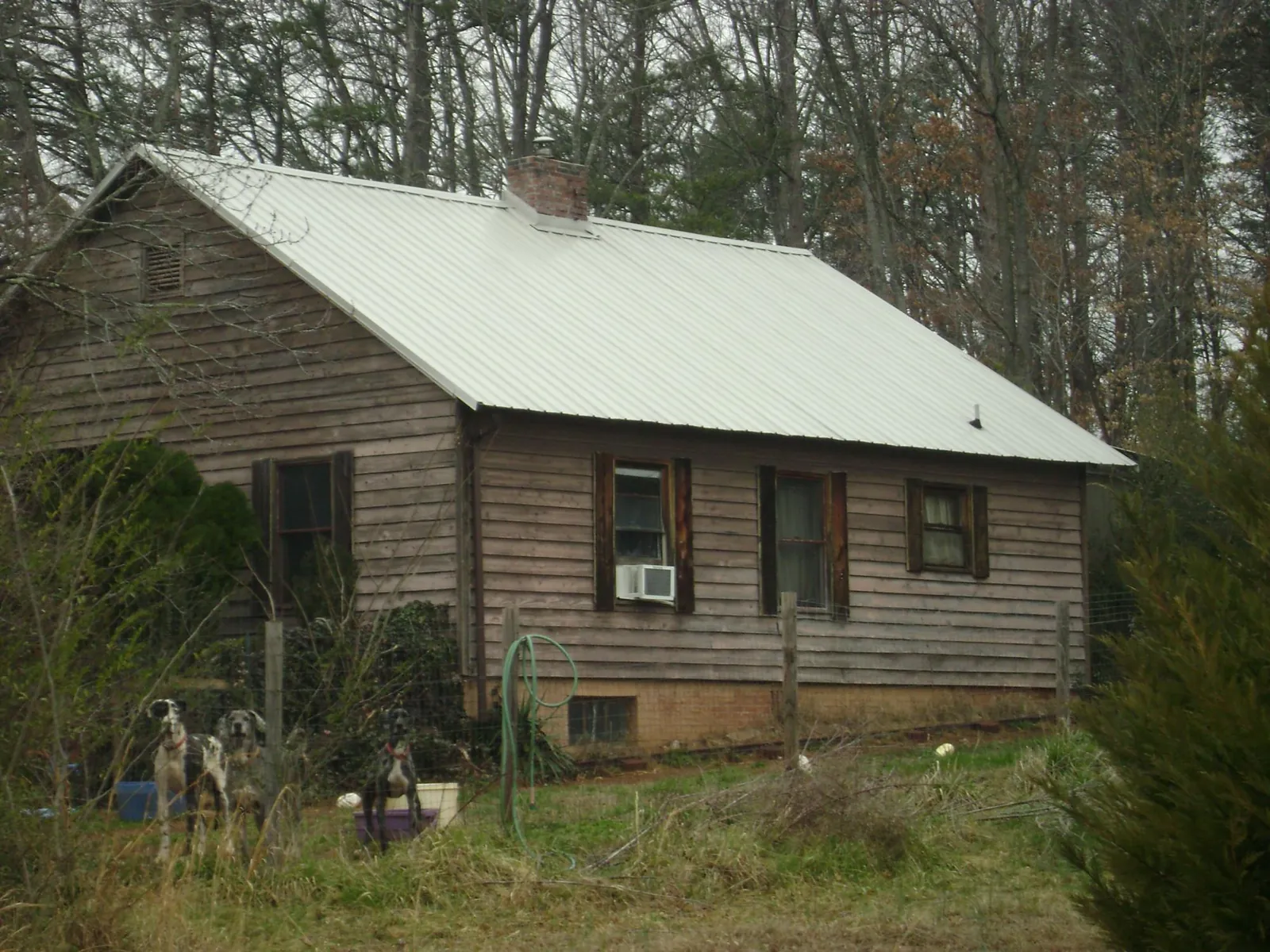 White metal roof on an old wood sided farmhouse, from a Metal Roof Installation job in Worcester